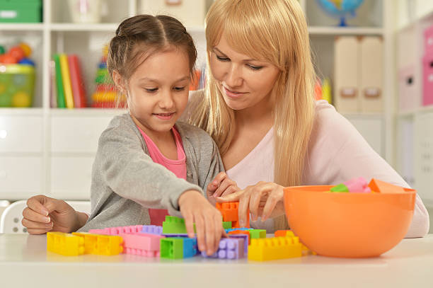 istock little girl playing with mother 504867170