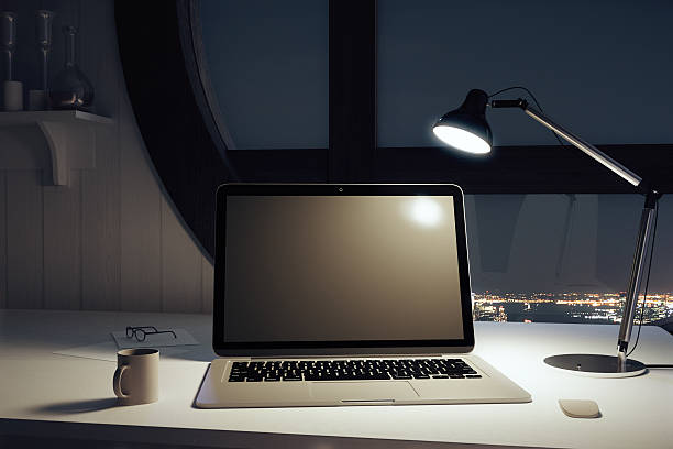 istock Black blank laptop with cup of coffee and lamp 504869018