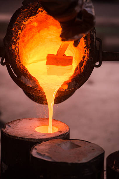 istock Foundry worker pouring hot metal into cast 504869632