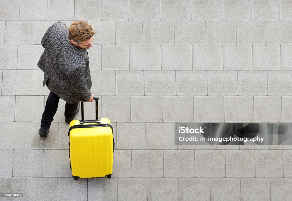 Travel man walking with suitcase Top view travel man walking with suitcase Suitcase Stock Photo