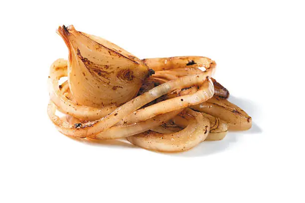 roasted onion pieces on a white background. closeup