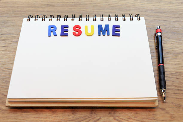 istock colorful letter resume lay down notebook on wood  background 504876102