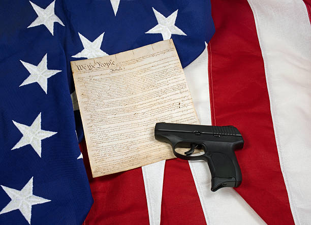 istock Constitution with Hand Gun on American Flag, Horizontal 504876126