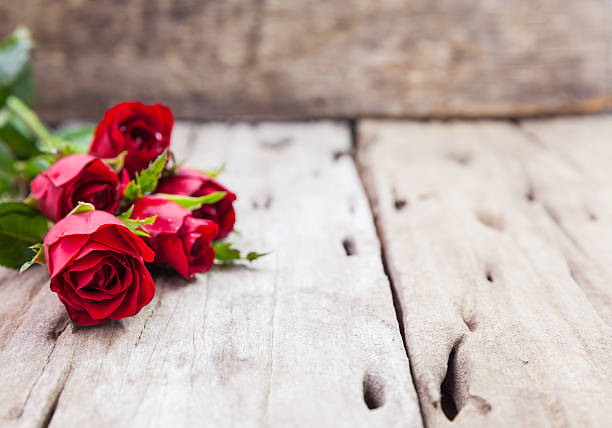 istock Red roses for Valentine's Day on blurred wooden background. 504879254