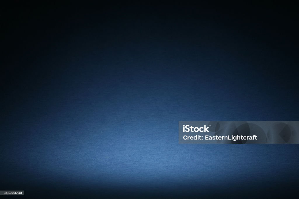 Blue Sweep Background With Vignette Blue background image made with curved paper and halo style vignette lighting. Ideal for the designer to add floating copy, objects with drop shadows. Selective focus on the lightest area of the halo Backgrounds Stock Photo