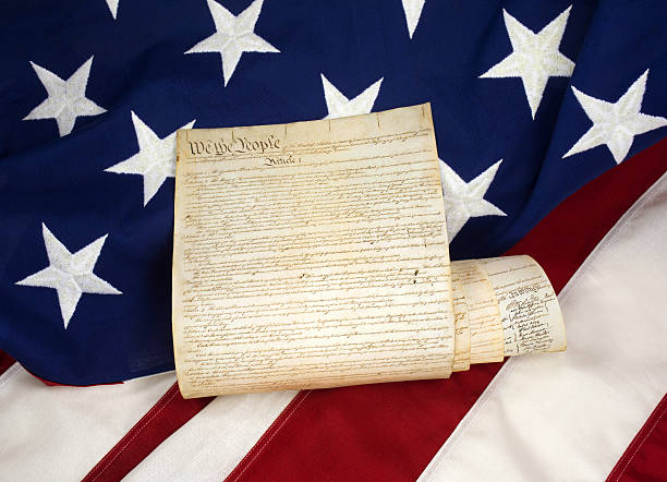 istock Rolled US Constitution on American Flag 504882588