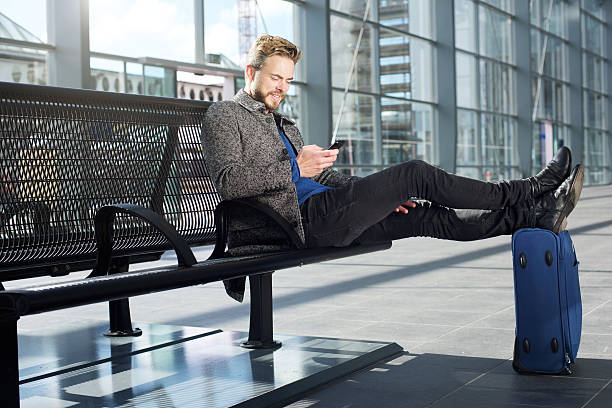 istock Handsome man relaxing at airport with mobile phone 504882712