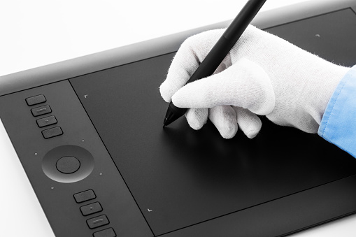 Varna, Bulgaria - January 10, 2016 Wacom Intuos pro graphic tablet with pen and human hand. Intuos is a product of Wacom a Japanese company specialized in graphics tablets and related products