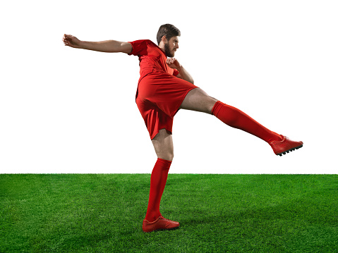 Isolated professional football player in action. A player wears unbranded soccer uniform.