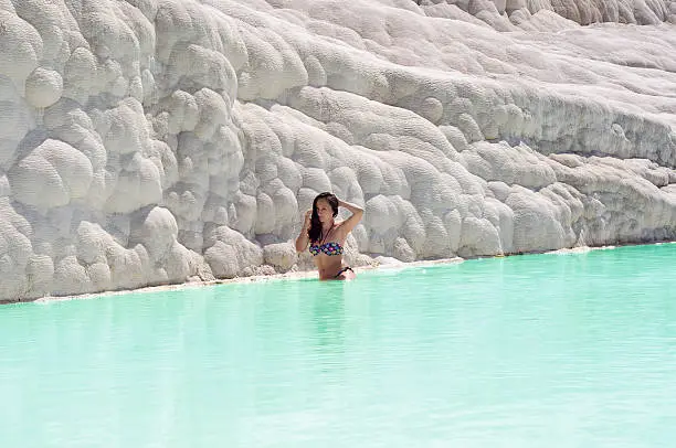 Photo of Woman sitting in travertine pool in Pamukkale, Turkey