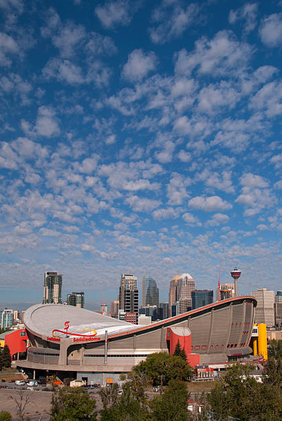 Saddledome with Calgary Skyline Calgary, Canada - August 23, 2012: Skyline of Calgary with the Scotiabank Saddledome at Stampede Park, home of the Calgary Stampede. scotiabank saddledome stock pictures, royalty-free photos & images