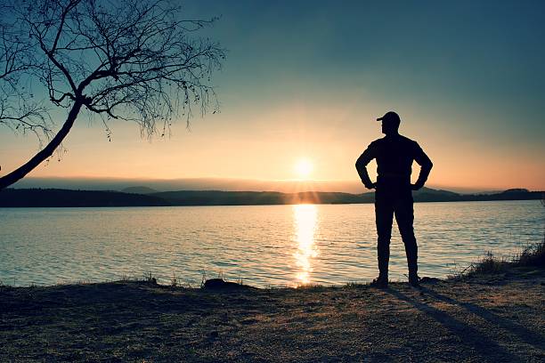istock Tall hiker on beach enjoy sunset with sky with clouds. 504885692