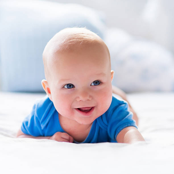 istock Baby boy in white sunny bedroom 504888014