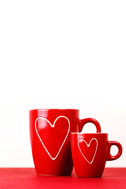istock Two red cups of tea or coffee with hearts 504891386