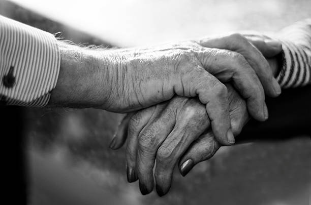 istock Old Couple holding hands closely 504891932