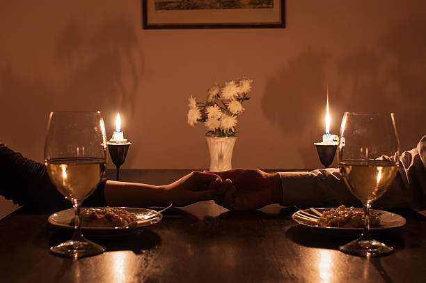 Romantic candle light dinner Loving couple holding hands during romantic dinner candle light dinner stock pictures, royalty-free photos & images