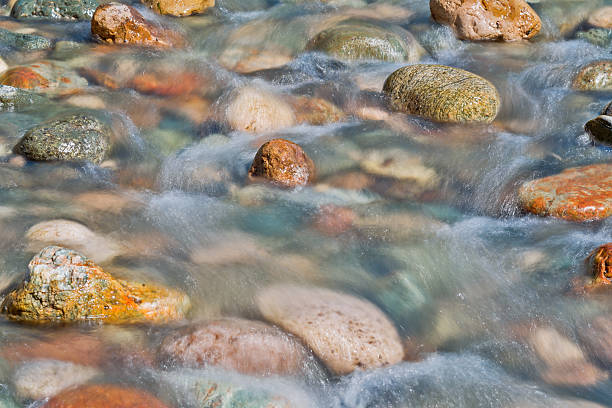 istock Pebble stones in the river water close up view, 504898744