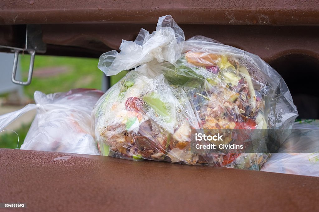 open dumpster full of trash dumpster full of bags of organic waste Food Stock Photo