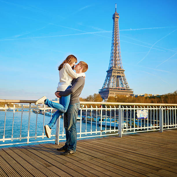 A loving romantic Asian couple share an intimate moment at the Eiffel Tower in Paris