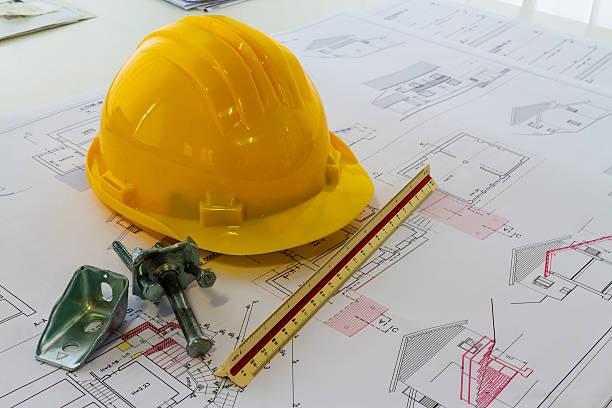 istock An office desk with the project papers and protective helmet 504900874