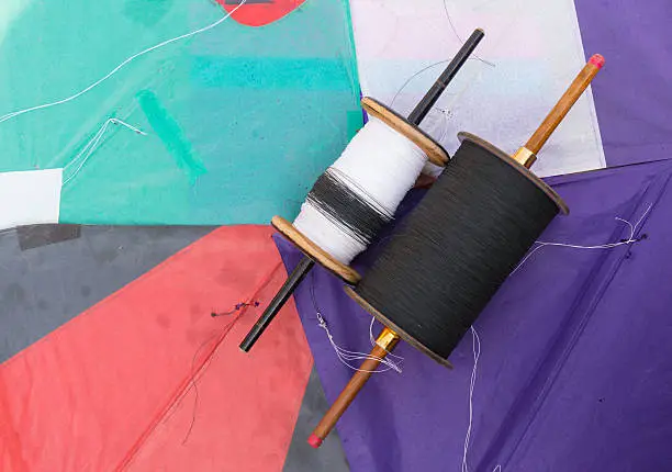 Photo of colorful indian paper kites and spool