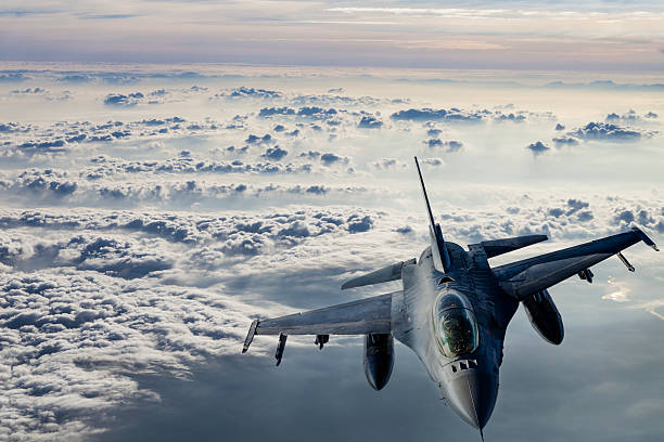 Fıghter Jet in flight Fıghter Jet flying over clouds. air force stock pictures, royalty-free photos & images