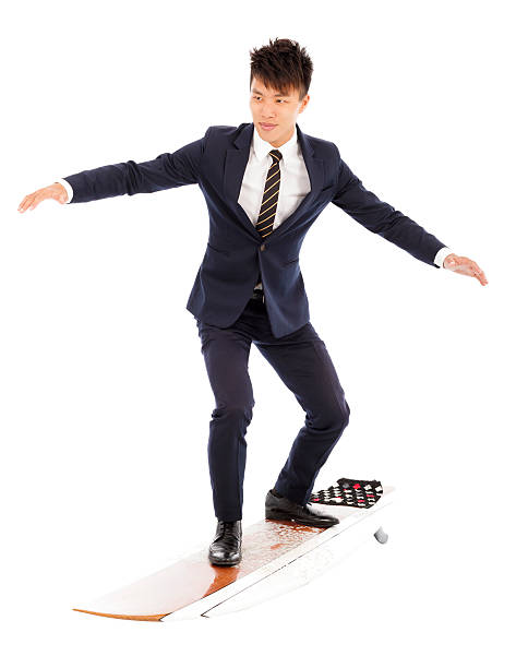 istock businessman practice surfing pose with suit 504903413
