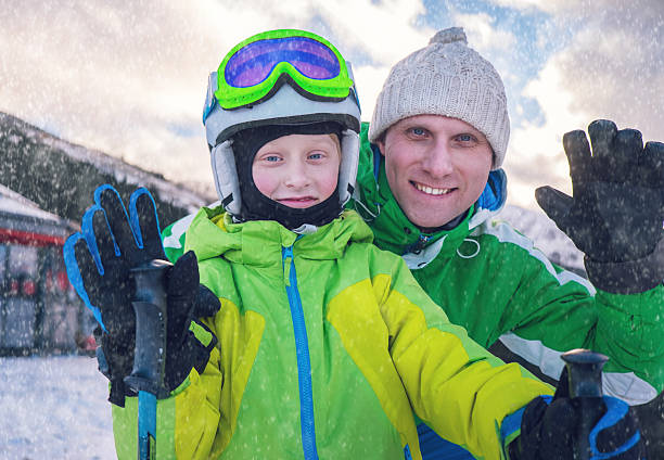 istock Father with son portrait on ski snow resort 504903456