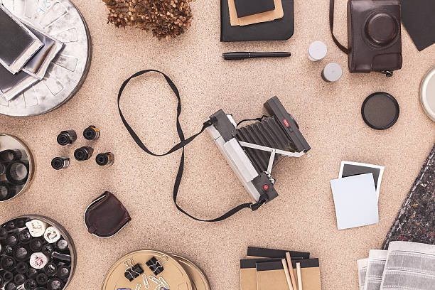 istock Polaroid Camera on a Photographers Desktop. Photographers Workspace Vintage. 504903522