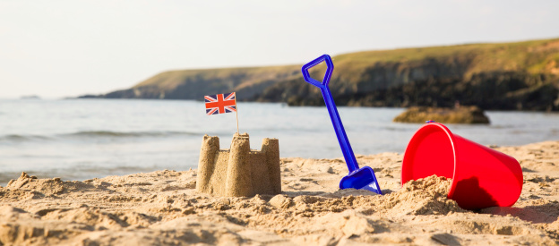 Beach, sea, bucket, spade and  sandcastle with union jack