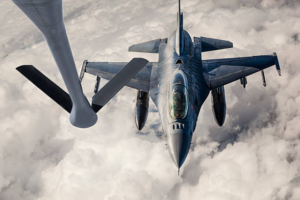 Fighter Jet Refueling Mid-air refueling of a Fıghter Jetfrom the boom pod of a KC-135 Stratotanker.  military tanker airplane photos stock pictures, royalty-free photos & images