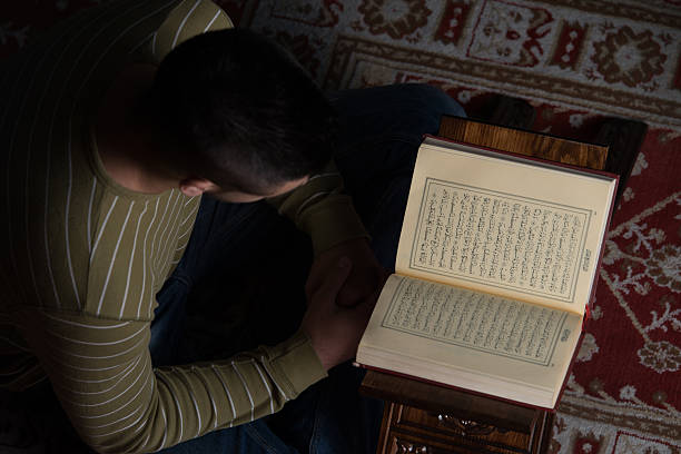 istock Arabic Muslim Man Reading Holy Islamic Book Koran 504906227