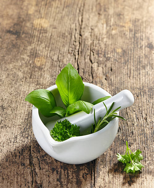 istock green herbs in a mortar and pestle 504906893