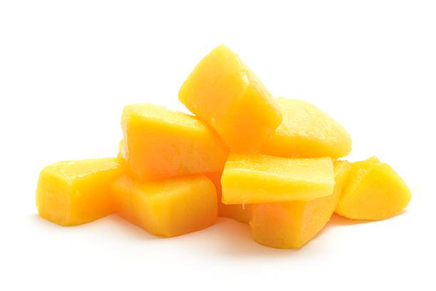 Mango chunks Fresh mango cut into chunks and isolated on a white background. mango fruit photos stock pictures, royalty-free photos & images