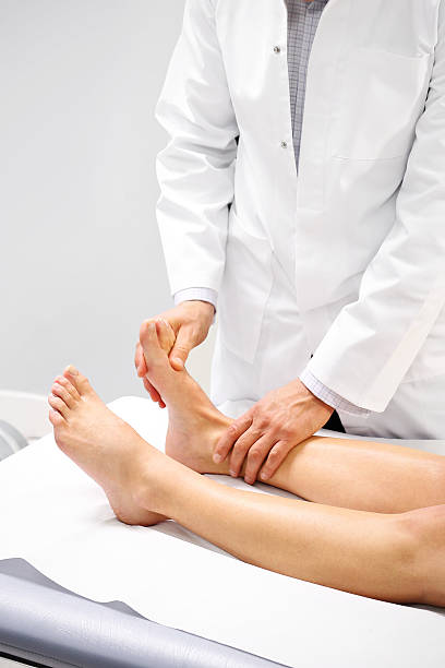 Orthopedic surgeon examines the patient's foot Orthopedic surgeon examines the patient's foot contributor stock pictures, royalty-free photos & images