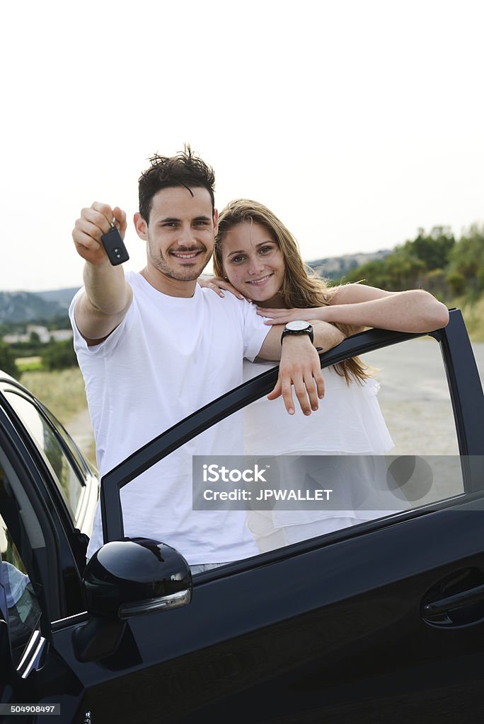 happy cheerful young couple driving new car holiday trip summertime happy and cheerful young couple driving new car during holiday trip in summertime in countryside Adult Stock Photo