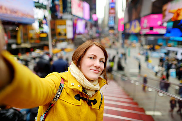 istock Beautiful woman taking a selfie on Times Square 504909176