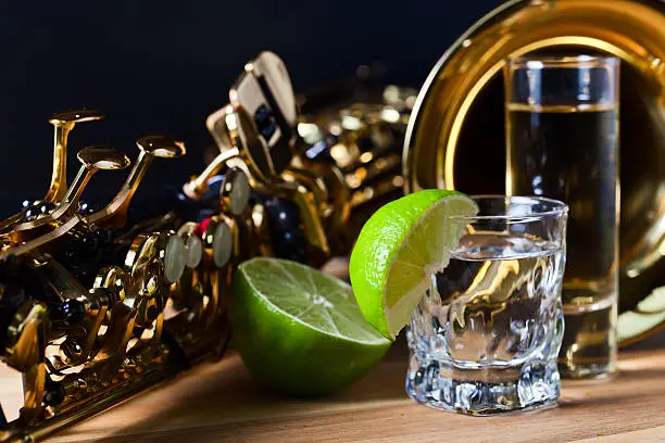 Photo of saxophone and tequila with lime