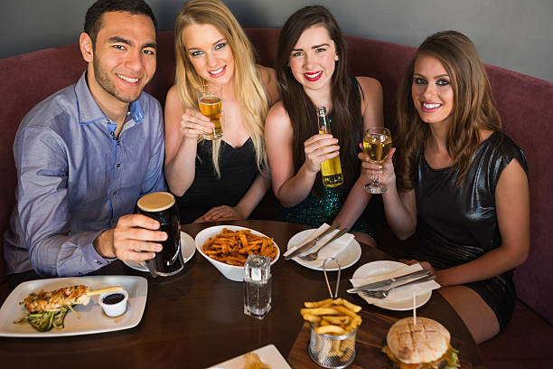 istock High angle view of happy friends having dinner together 504909371