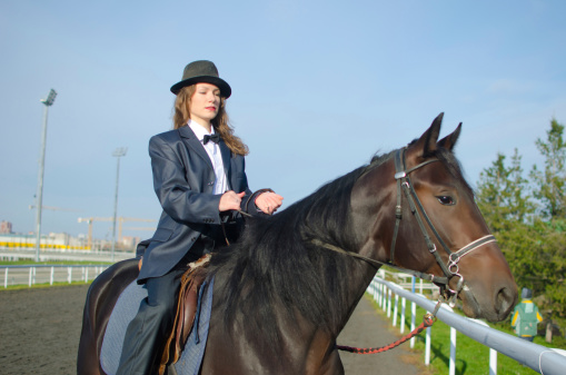 Woman in suit on a horse