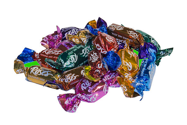 Cadbury Roses Darmstadt, Germany - January 14, 2016: Individually wrapped chocolates with a variety of fillings, out of a box of Cadbury Roses. Often these are purchased in the UK and Ireland as Christmas or birthday gifts. cadbury plc photos stock pictures, royalty-free photos & images