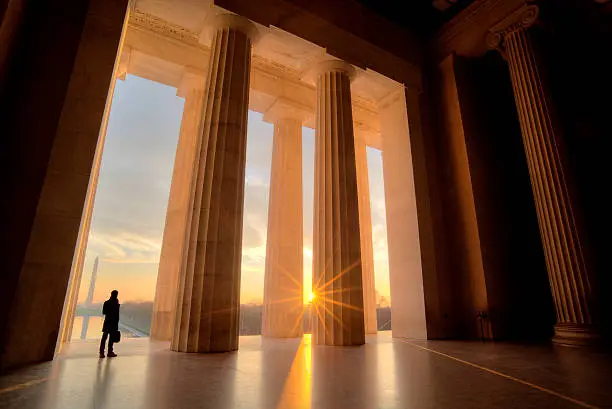 Businessman inside Lincoln Memorial at sunrise