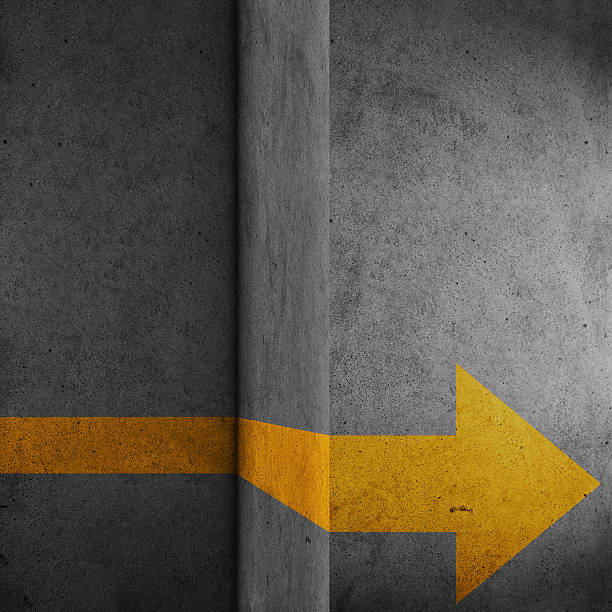 istock Abstract concrete block with yellow arrow sign 504911108