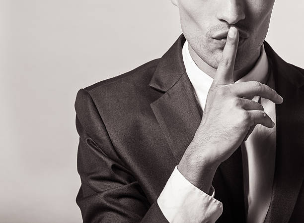 Shhh! Portrait of a young businessman with finger on his lips finger on lips stock pictures, royalty-free photos & images