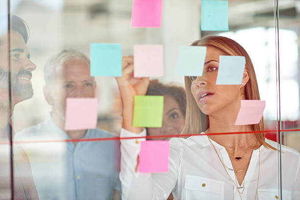 istock Using glass door to make presentation to her colleagues 504913200