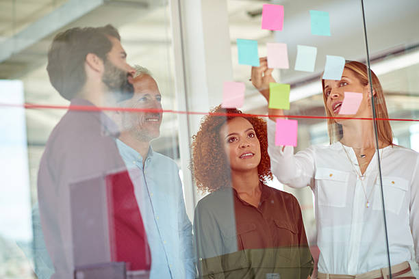 istock Using glass door to make presentation to her colleagues 504913360