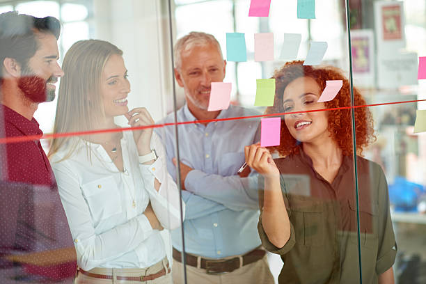 istock Using glass door to make presentation to her colleagues 504913676