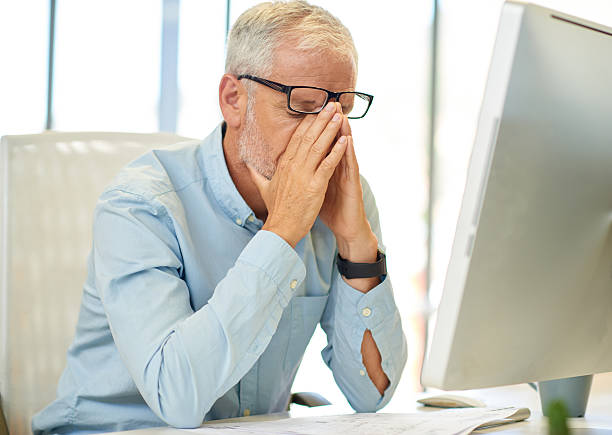istock Businessman looking tired in real office location 504918606
