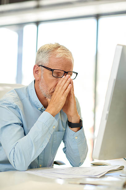 istock Businessman looking tired in real office location 504918764