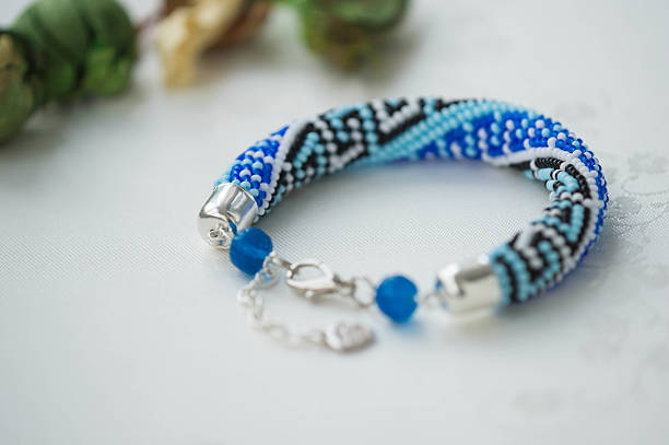 istock Bead Crochet Bracelet with ornament on textile background 504924658
